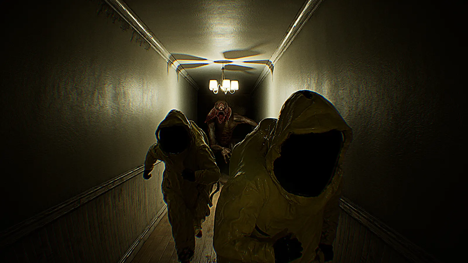 Two researchers run through a dark corridor while a hostile entity follows behind