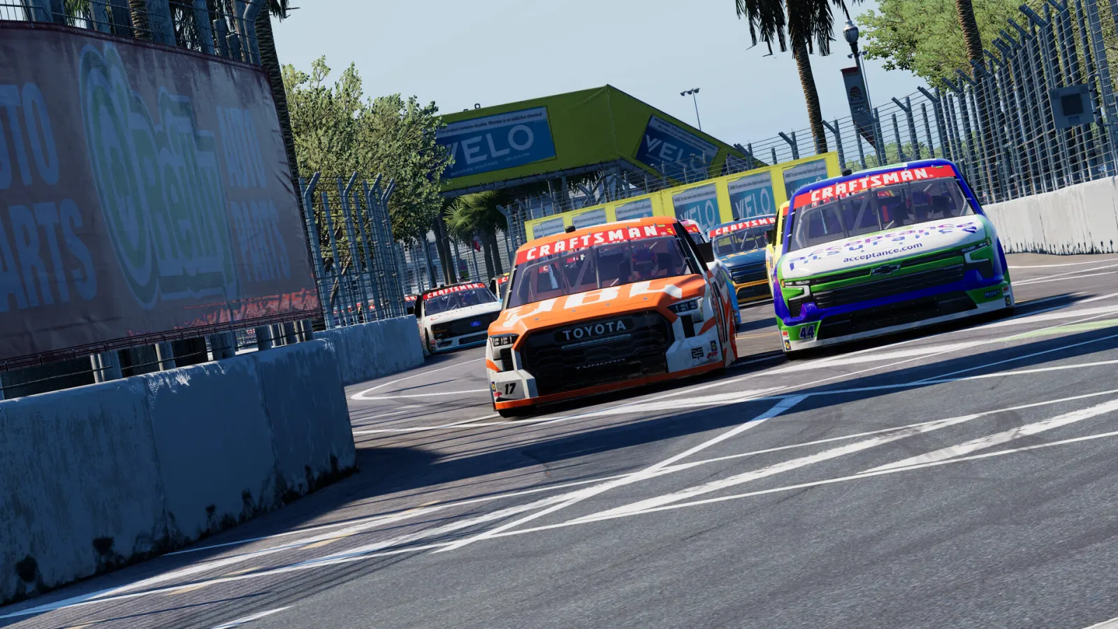 NASCAR Craftsman Truck Series vehicles contest a tight street-circuit corner in NASCAR 26