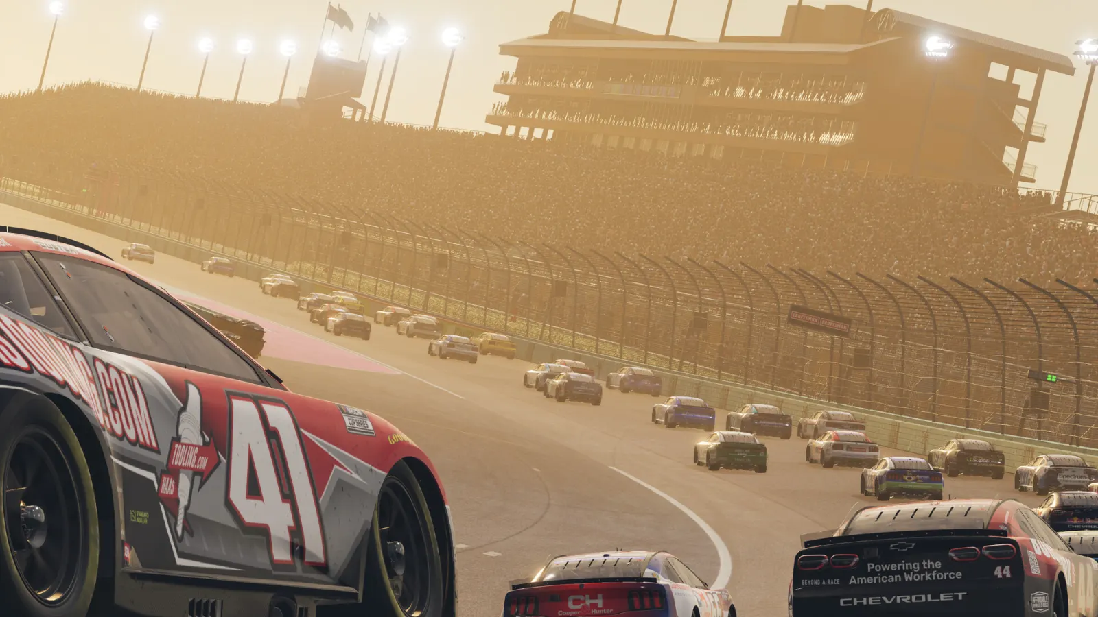 A full NASCAR Cup field races through a sunlit oval corner in NASCAR 26