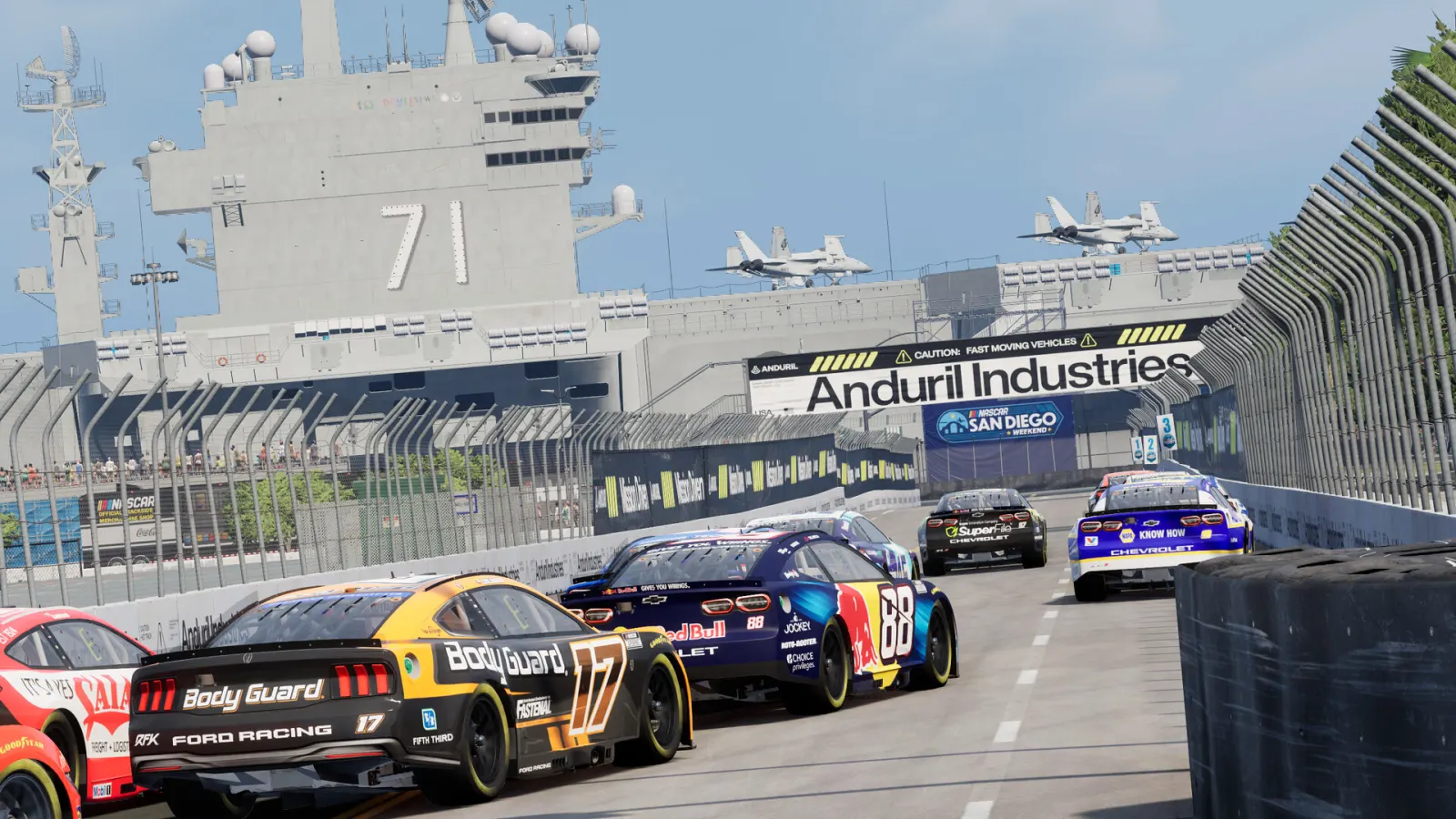 NASCAR Cup cars race past an aircraft carrier on the San Diego street circuit in NASCAR 26