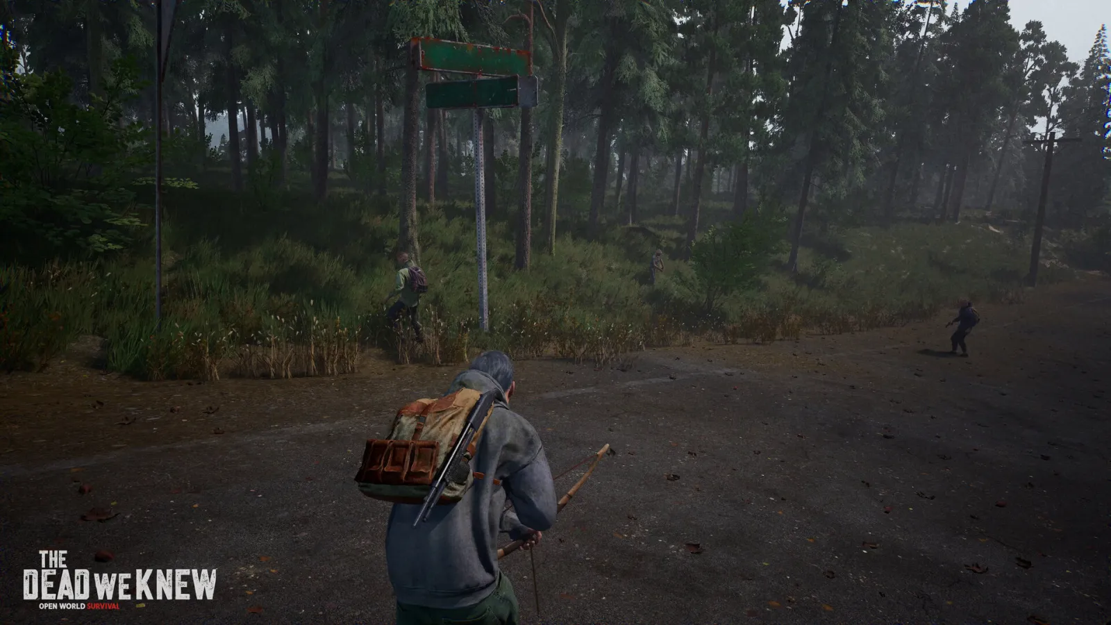 Official THE DEAD WE KNEW screenshot showing a survivor approaching zombies on a forest road